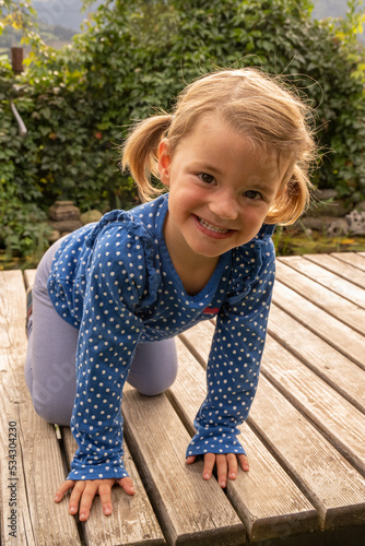 Girl in blue dress looking into the camera