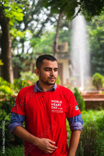 South asian young male medical student wearing red t shirt in awareness about world heart day campaign 