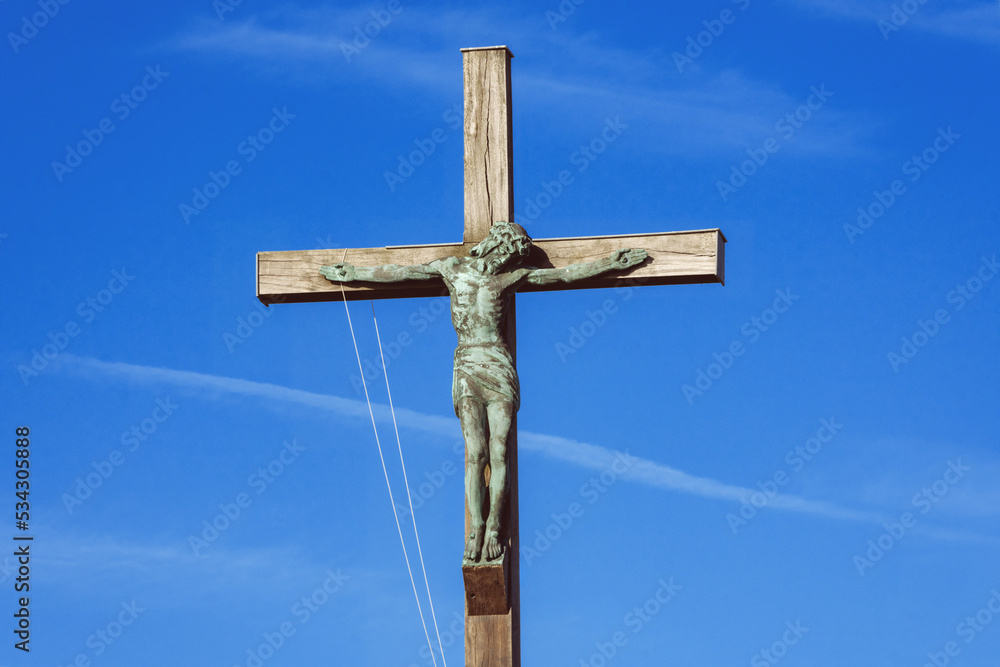 Statue of Christ on the cross against a blue sky