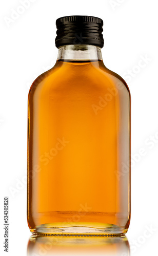 Canvas Print A small bottle of whisky, rum, or brandy, is isolated on white background