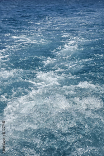 Sea view from stern of yacht. Trace on water from yacht's engine. Sea foam. Copy space. Close-up. Selective focus.