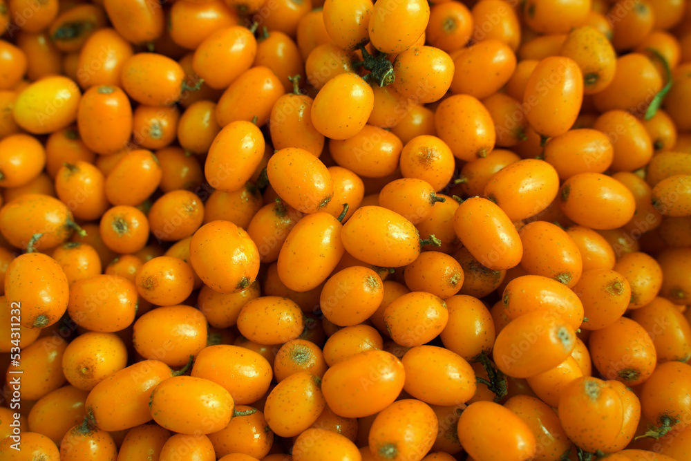 Ripe sea buckthorn berries background. Concept of healthy eating. Selective focus, macro photography.