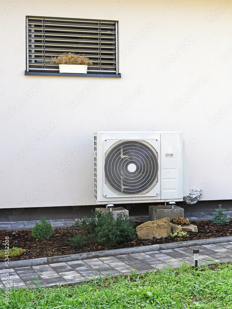 Heat pump or air conditioning outdoor unit in modern house of future using green electric energy, heat pump - efficient source of heat
