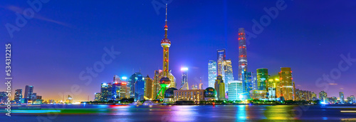 View of the skyline along the riverside at night in Shanghai, China.