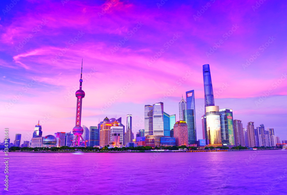 Fototapeta premium View of the skyline along the riverside at dusk in Shanghai, China.