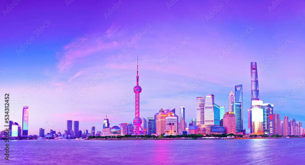 View of the skyline along the riverside at dusk in Shanghai, China.