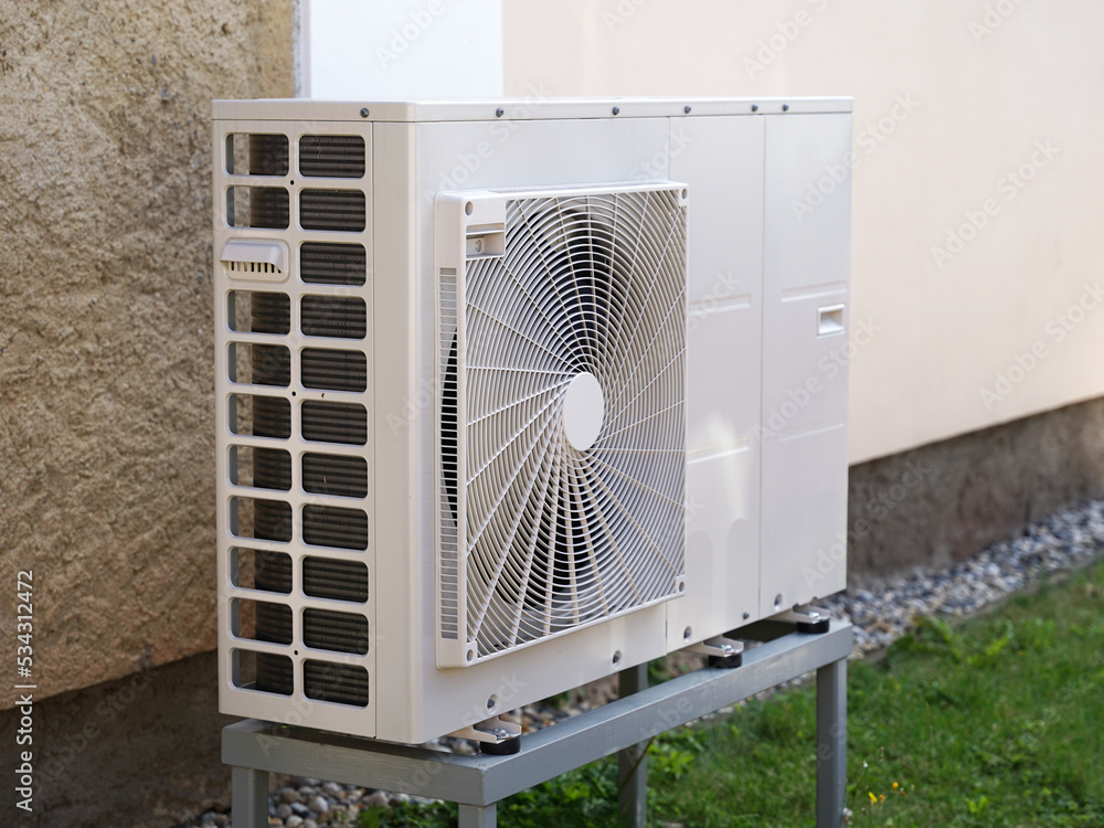 Heat pump or air conditioning outdoor unit in modern house of future using green electric energy, heat pump - efficient source of heat