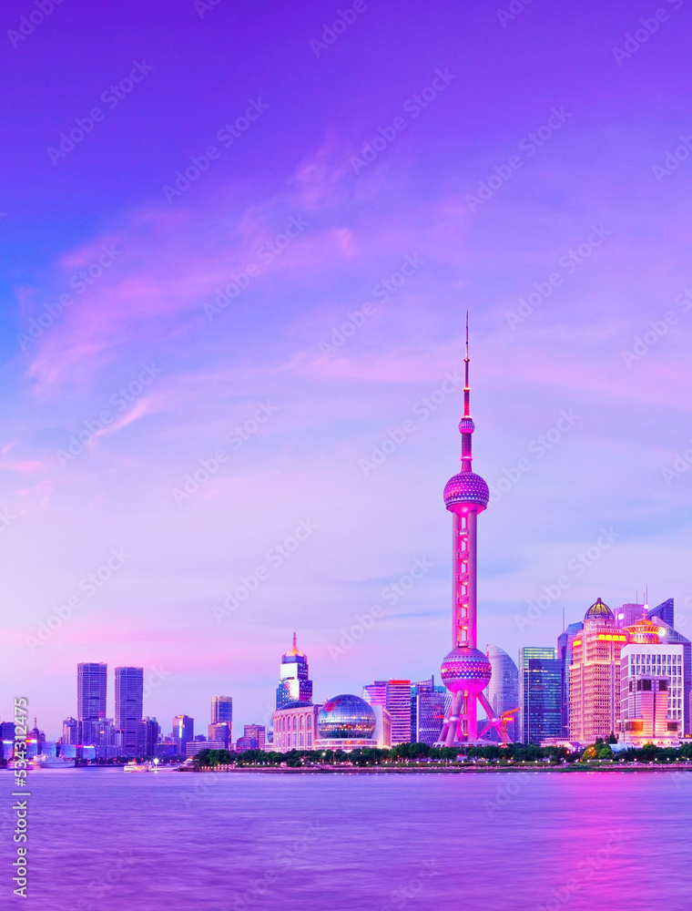 View of the skyline along the riverside at dusk in Shanghai, China.