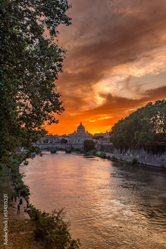 Vertical Panoramic View of the Dome of the Basilic of Saint Peter in Rome beside the Bridge on the Tevere River in Rome at Sunset