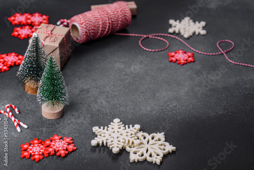 Fototapeta Naklejka Na Ścianę i Meble -  Christmas toys and decorations on a dark concrete background