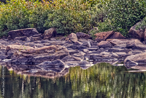 Water acts as a reluctant mirror when it flows , Thunder Bay, ON, Canada photo