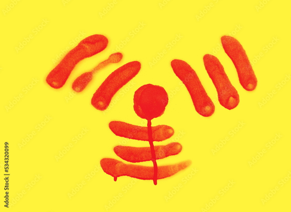 Fototapeta premium Red spray stain in shape radiation symbol on yellow background