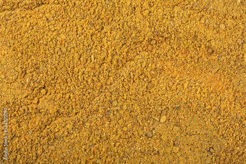 Pile of curry powder as background, top view.