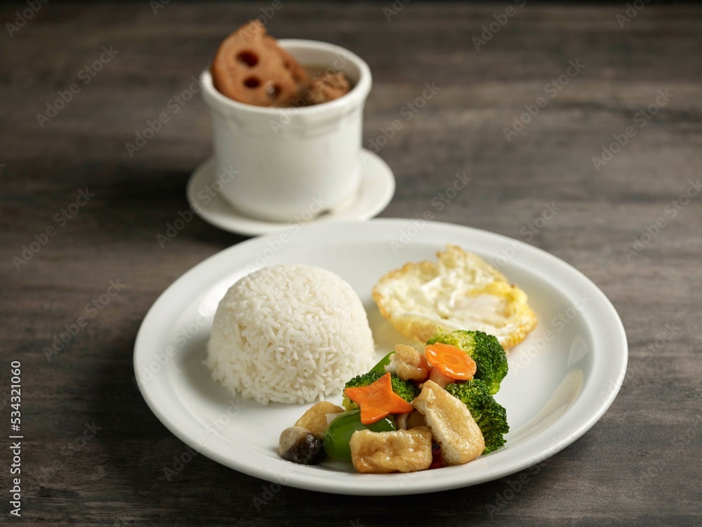 Thick Mushroom with Broccoli, rice and Bean Curd Skin served in a dish isolated on table side view