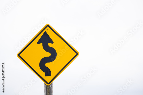 The road ahead is a winding road. warning sign