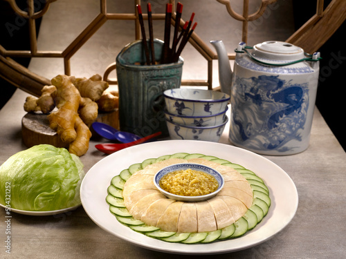 Samsui Ginger Chicken Final with cucumber served in a dish isolated on table side view photo