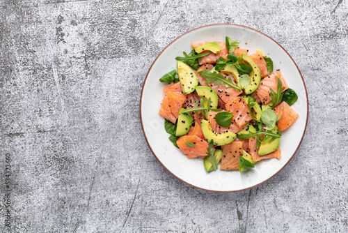 Salmon salad with avocado,  for keto and low carb diet. Rusty background, top view, copy space.