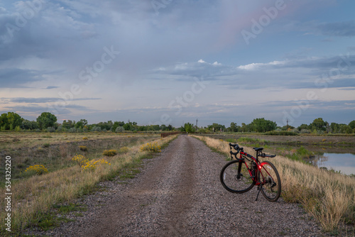 gravel bike with head and tail lights on a dirt road in Colorado countryside