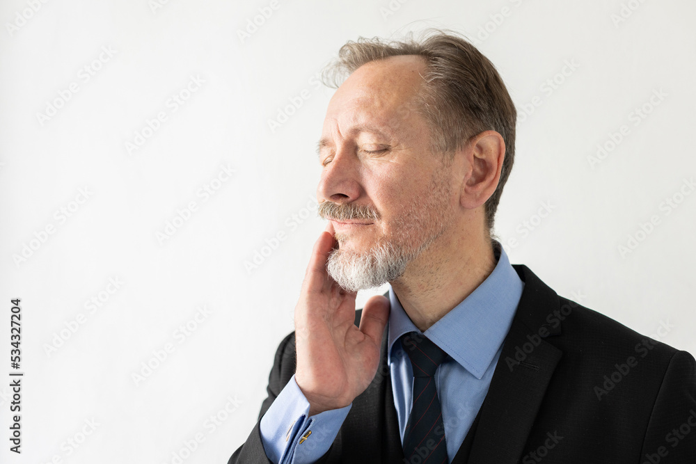 Portrait of unwell mature businessman touching his cheek. Senior Caucasian manager wearing formal suit standing with eyes closed suffering from toothache. Toothache concept Portrait of unwell mature businessman touching his cheek. Senior Caucasian manager wearing formal suit standing with eyes closed suffering from toothache. Toothache concept