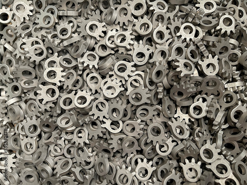 batch of metallic steel parts, mass production of toothed sprockets, lots of steel parts, fine blanking of gear wheels, manufacture of car parts, cold stamping of components