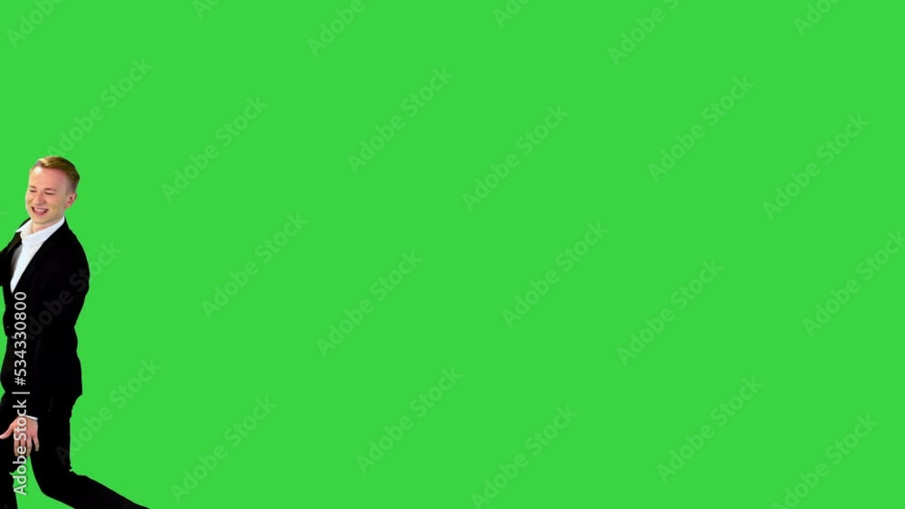 Two young caucasian guys in office suits meet, hold hands, lean back and walk away on a Green Screen, Chroma Key.