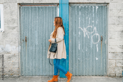 woman walking on the street in autumn © carballo