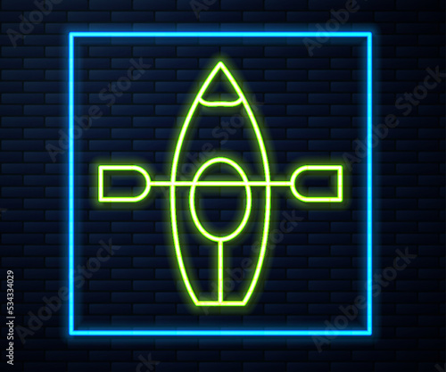 Glowing neon line Kayak and paddle icon isolated on brick wall background. Kayak and canoe for fishing and tourism. Outdoor activities. Vector