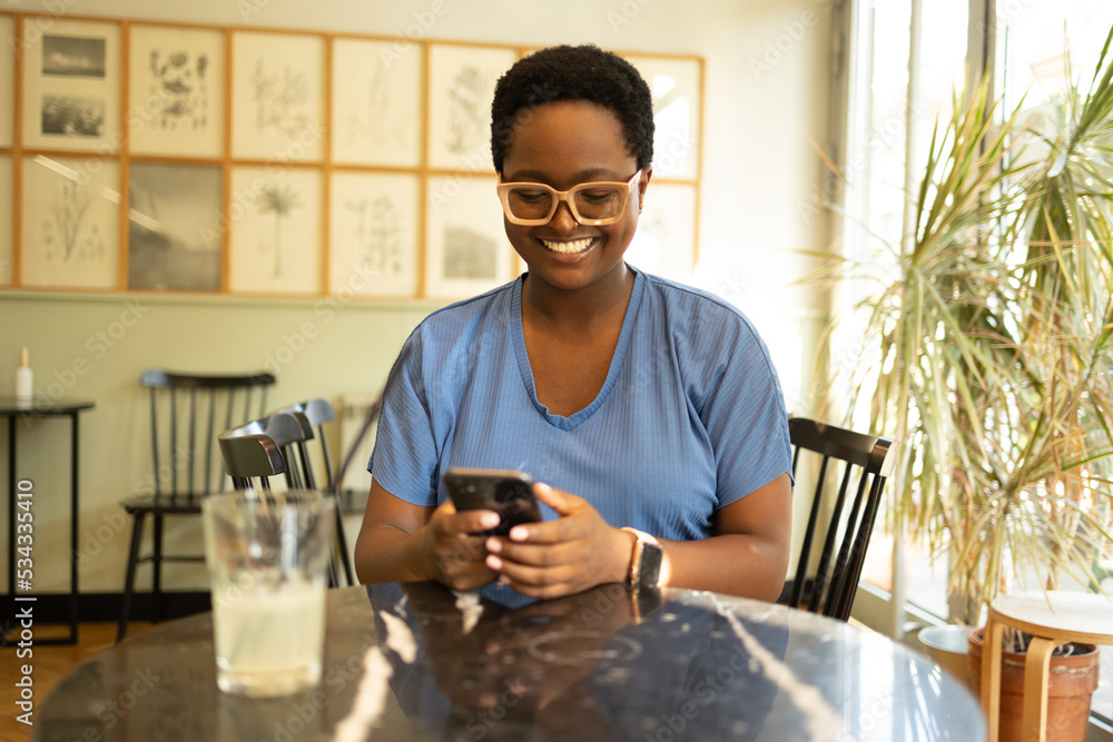 Smiling African American using mobile phone