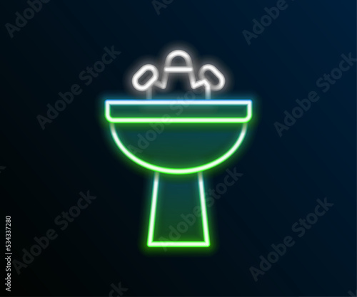 Glowing neon line Washbasin with water tap icon isolated on black background. Colorful outline concept. Vector
