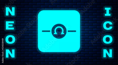 Glowing neon Ohmmeter icon isolated on brick wall background. Vector