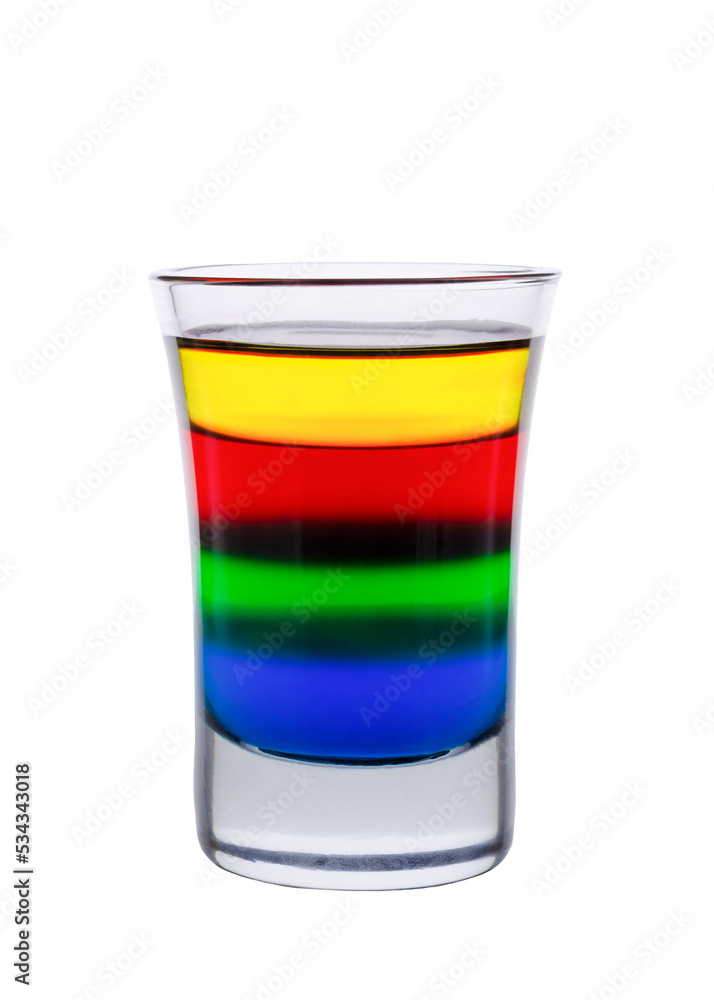 Colored water layers in a shot glass isolated on white background Colored water layers in a shot glass isolated on white background