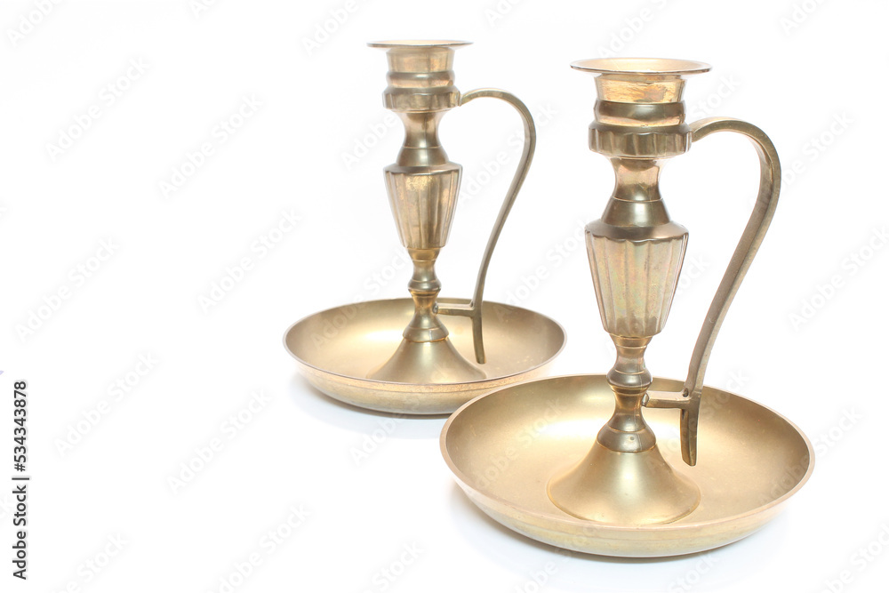 Old, brass, ornate candlestick candle holder, shiny, but with light patina, isolated on a white background. 