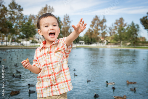 Young Chinese and Caucasian Boy Having Fun at the Park and Duck Pond.