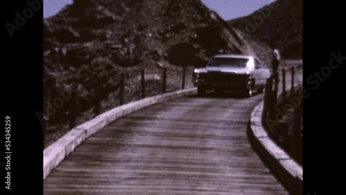 Driving on the Twin Trestles 1969 - A car drives on one of the Twin Trestles that once carried a rail line above Devil's Slide in the Rocky Mountains of Colorado, seen in 1969.  photo