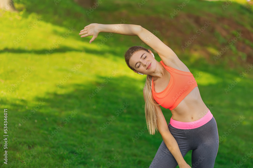 Young female workout before fitness training session at the park. She is stretching her arms and looking away,hi key. Young female workout before fitness training session at the park. She is stretching her arms and looking away,hi key.