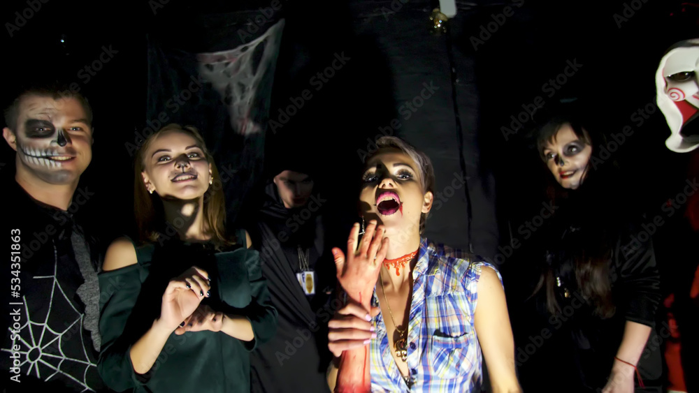 Halloween party, night, twilight, in the rays of light, young people frighten the spectators, everyone is dressed in scary costumes for Halloween. High quality photo Halloween party, night, twilight, in the rays of light, young people frighten the spectators, everyone is dressed in scary costumes for Halloween. High quality photo