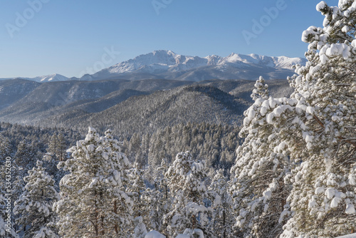 USA, Colorado, Pike National Forest. Distant Pikes Peak and March snowfall on mountains. photo