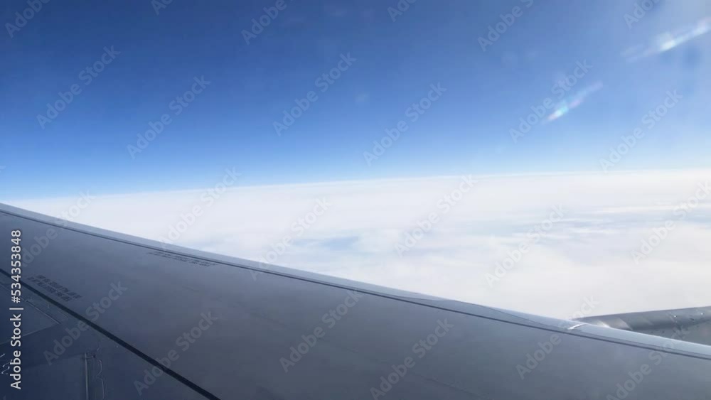 Beautiful view of the clouds through the porthole. View from the window of the aircraft. Airplane wing through the porthole. Beautiful view of the clouds through the porthole. View from the window of the aircraft. Airplane wing through the porthole.