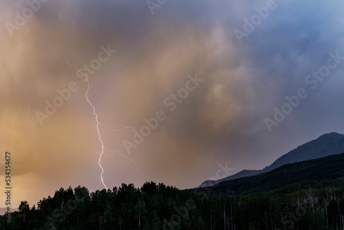 USA, Colorado, Gunnison National Forest. Lightning bolt in mountains at sunset.