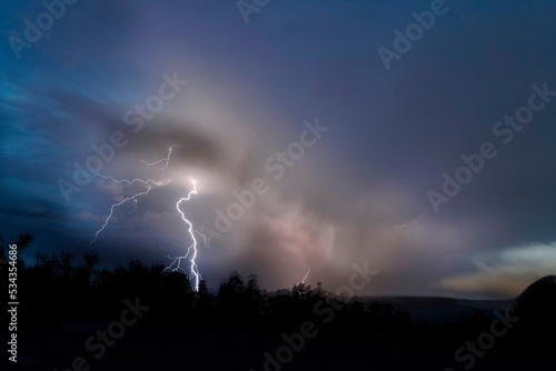 USA, Colorado, Gunnison National Forest. Lightning bolt in mountains at sunset.