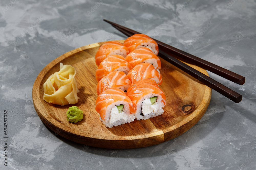 Traditional delicious fresh sushi roll set on a black background