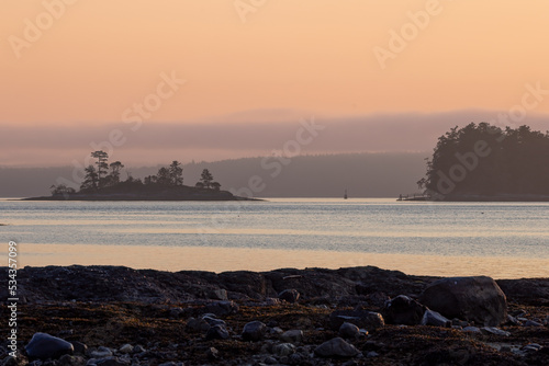 Pastel pink and purple sky over islands and sea © Kelly