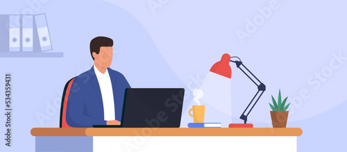 Man sitting at desk and working with a laptop