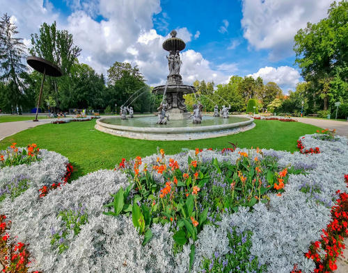 Beautiful fountain in the city park Stadtpark, a green island in the middle of the city center of Graz, Styria region, Austria. Selective focus