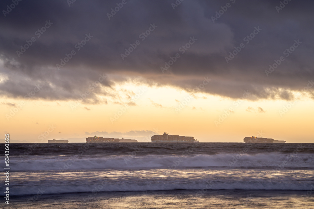 Cargo Ships offshore next to Long beach port at sunset