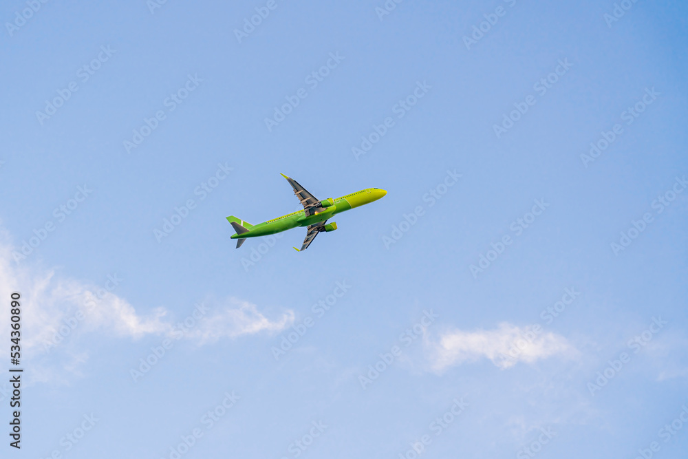 the plane is flying against the blue sky the plane is flying against the blue sky