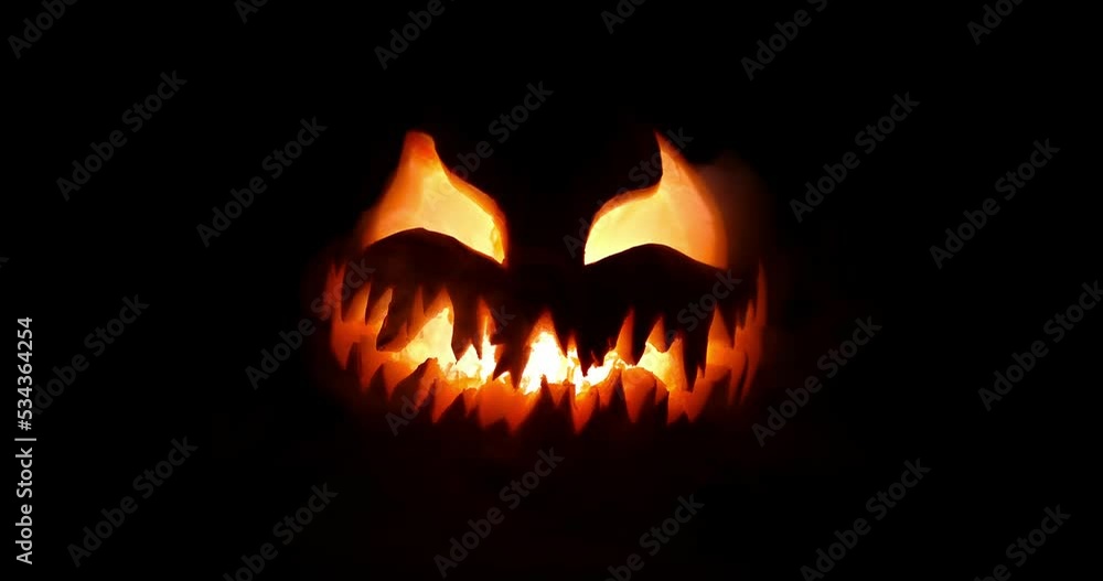 Spooky Halloween jack o lantern with scary face carved out of a pumpkin glowing with flickering light and emitting smoke. Spooky Halloween jack o lantern with scary face carved out of a pumpkin glowing with flickering light and emitting smoke.