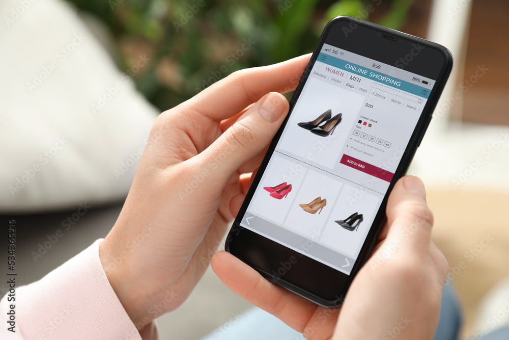 Woman using smartphone for online shopping indoors, closeup Woman using smartphone for online shopping indoors, closeup