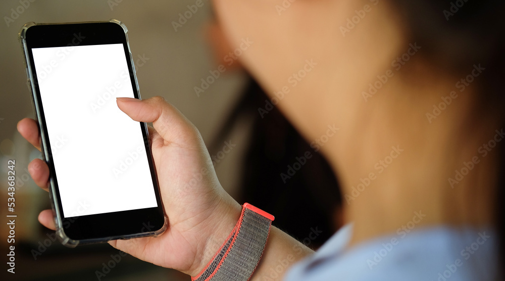 Woman holding mock up smart phone with blank screen..