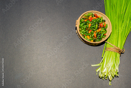 Chinese chives or garlic chives, along with chiltepin chili. Ingredients for the preparation of chiltepin chilli sauce photo